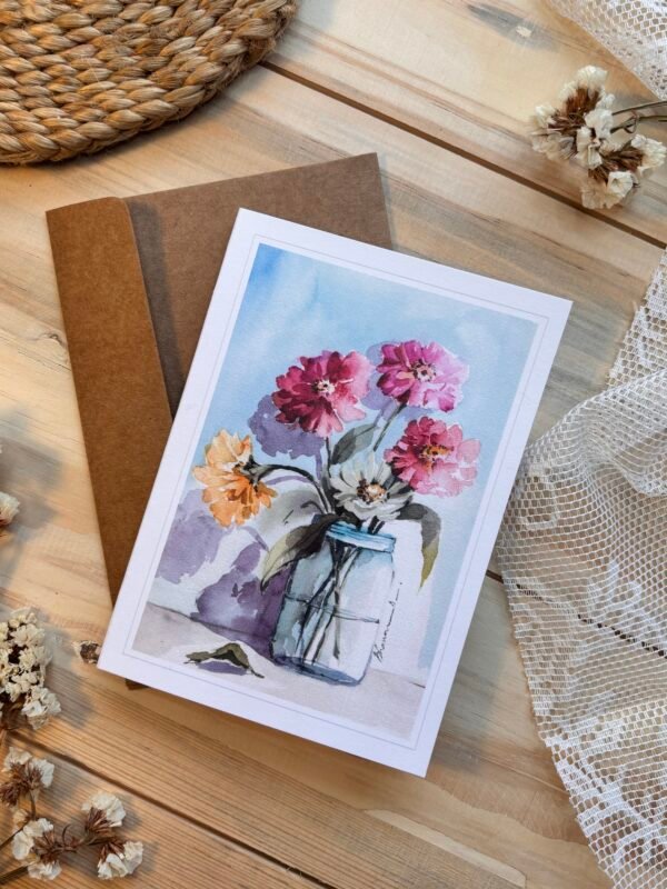 bloomed roses in the glass vase on the greeting card