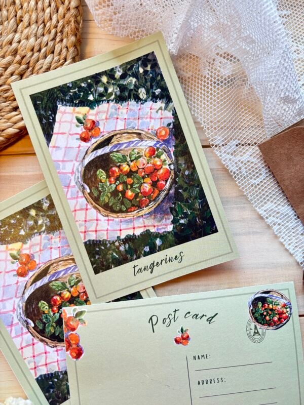 postcard shows basket filled with tangerine placed on the table