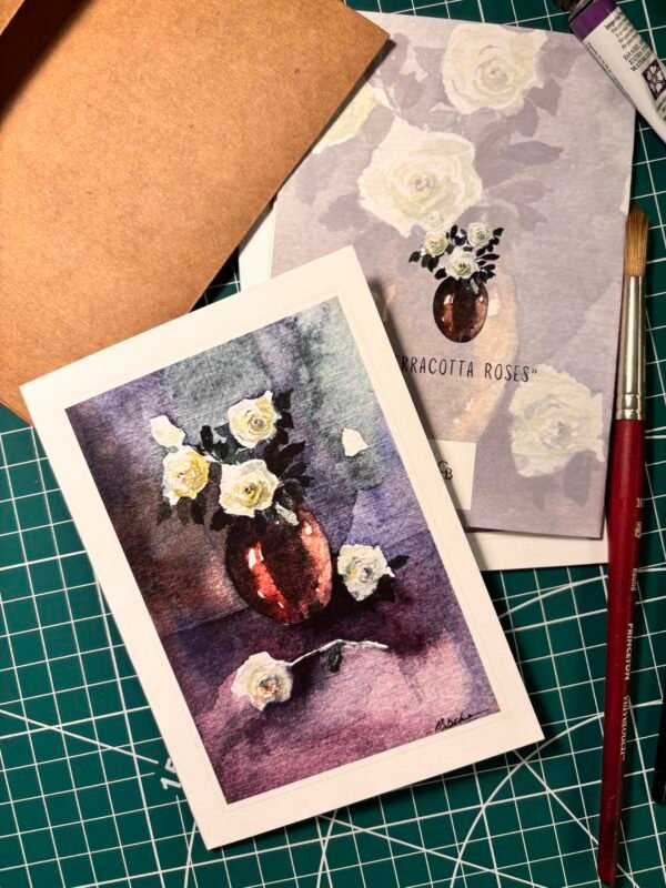 front & back of terracotta greeting card with painting brush placed next to it