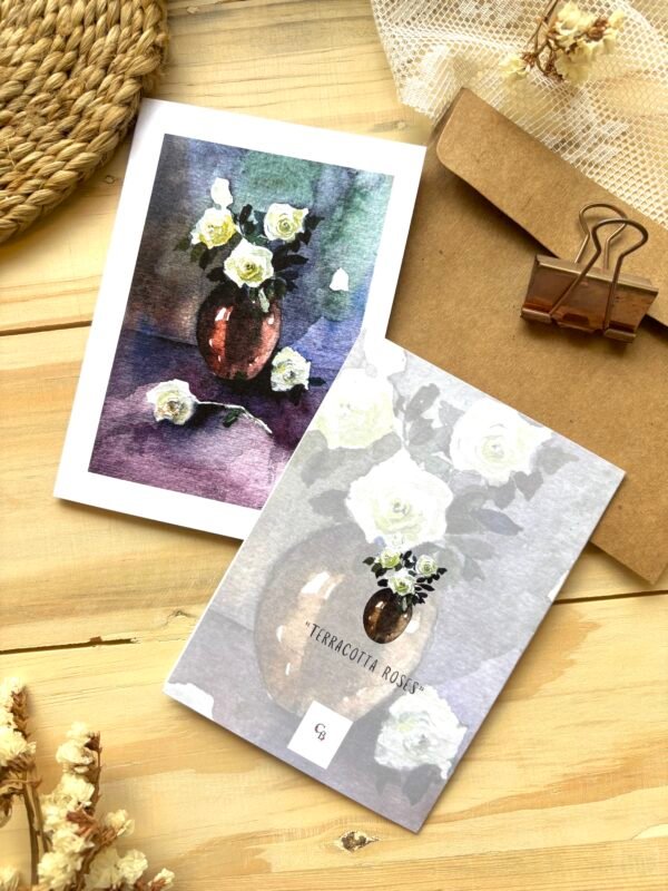 terracotta roses greeting card front & back with brown envelope behind it with black clip on it