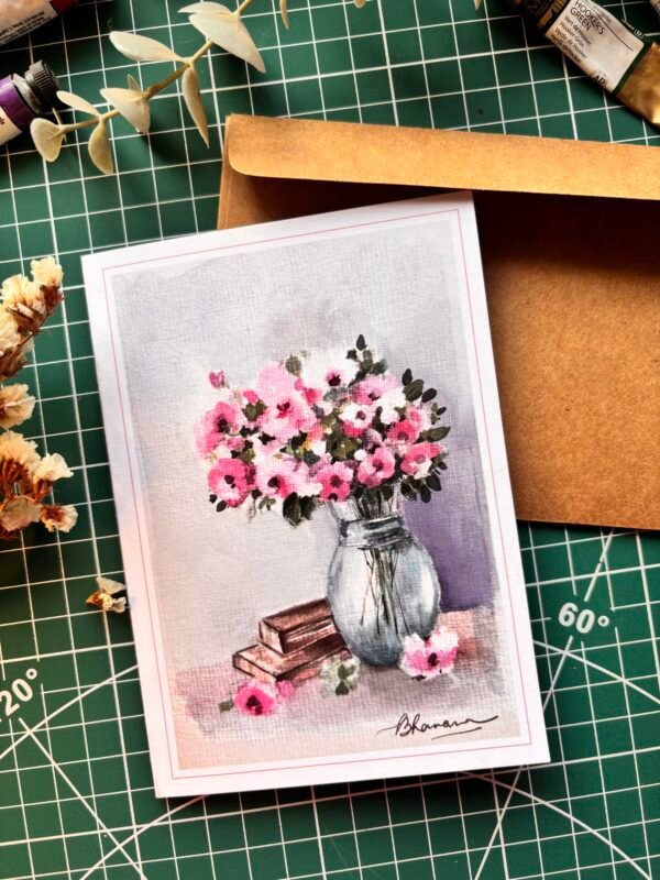 a bunch of mixed flowers in the glass vase with books next to it