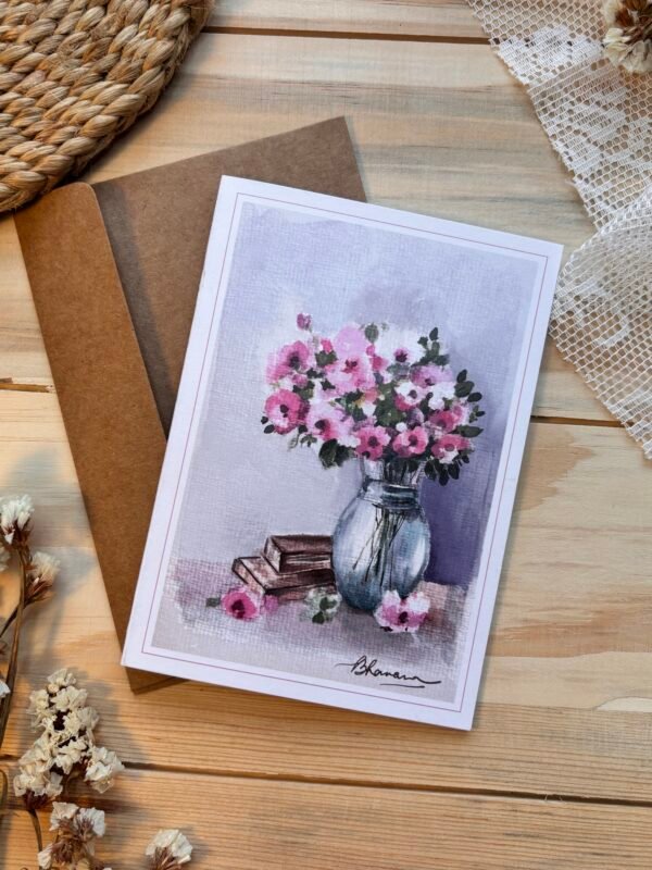 a bunch of mixed flowers in the glass vase with books next to it