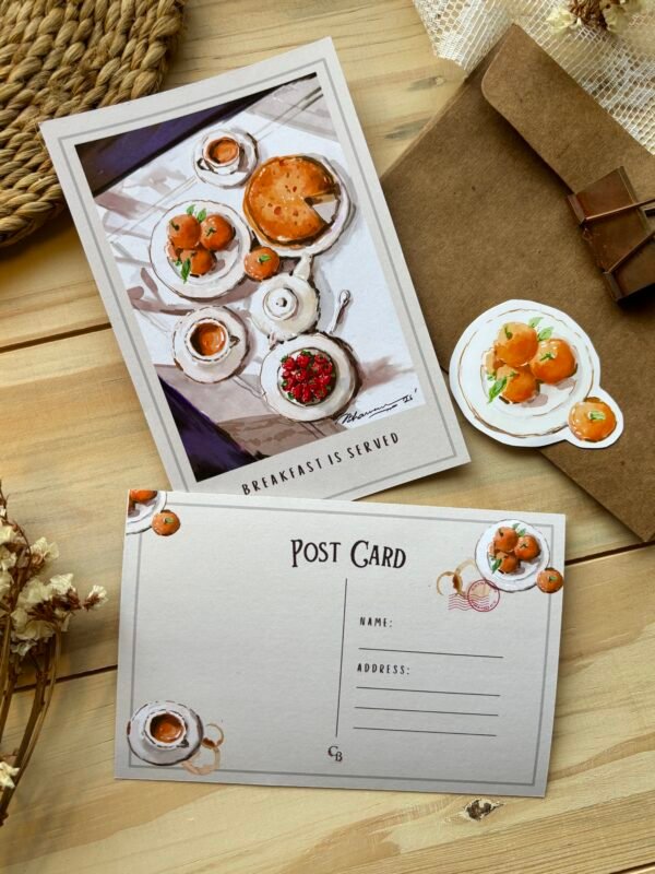 postcard with breakfast items on it with matching sticker next to it on the brown envelope