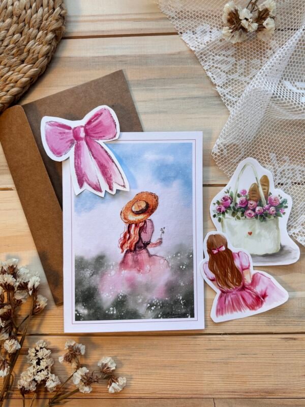 a greeting card with three stickers along with it with brown envelope at the back
