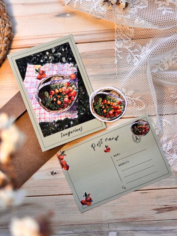 postcard with basket filled with tangerines with matching sticker on the table